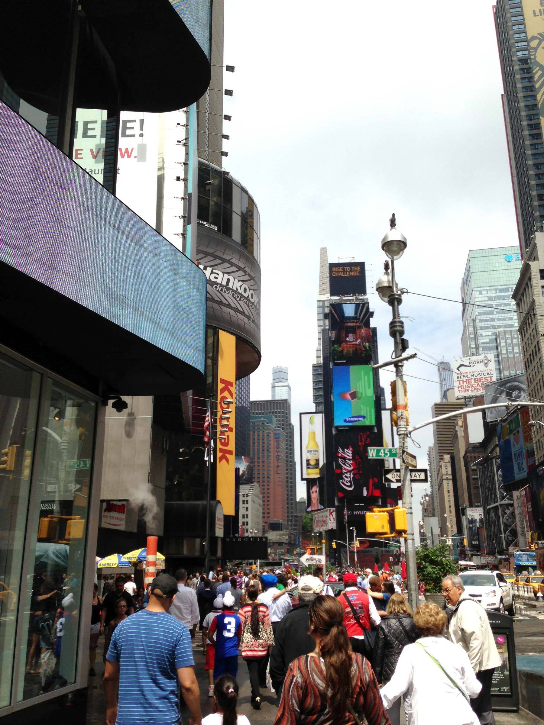 Pedestrians walking down Time Square