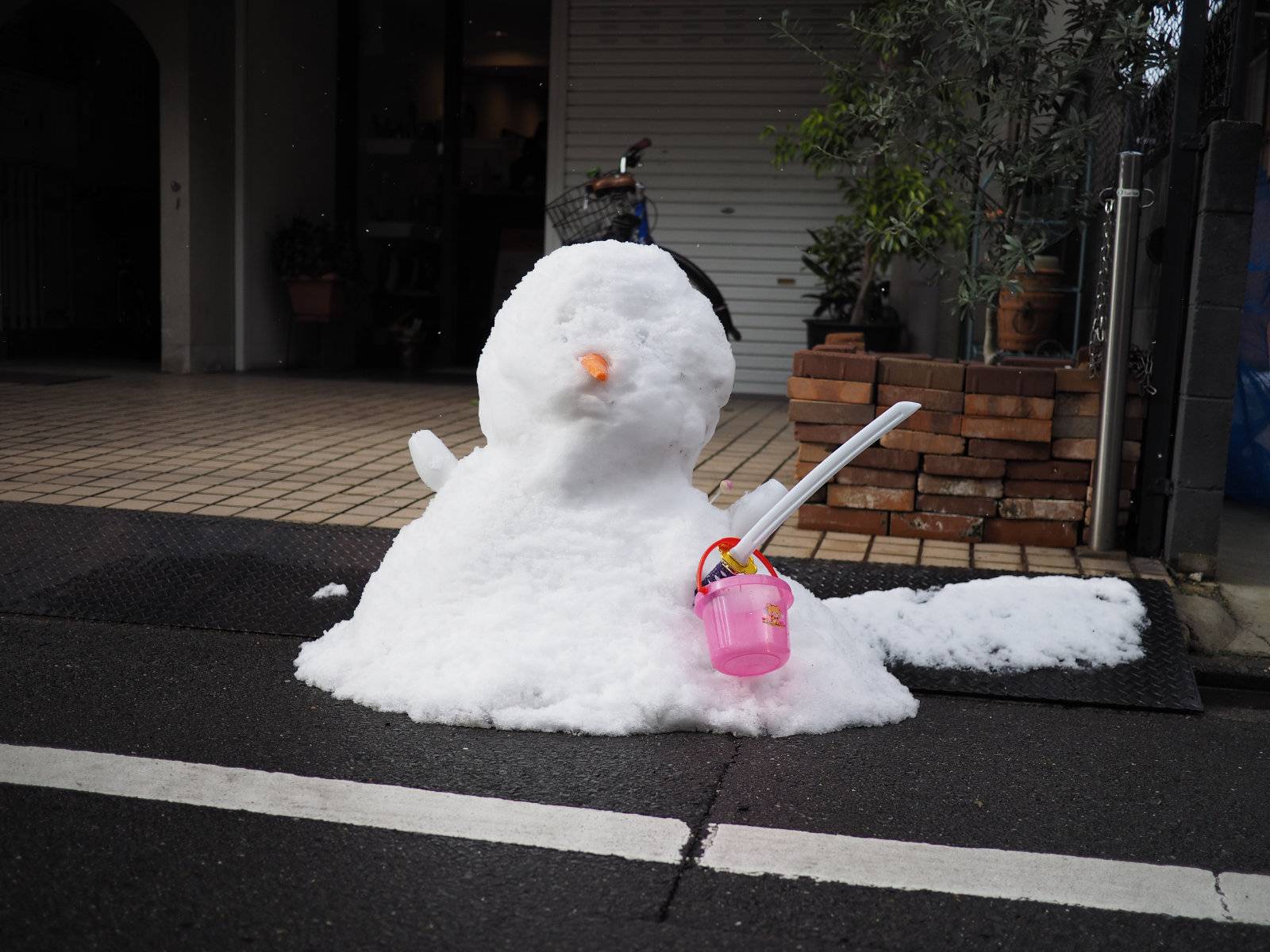 Snowman outside a family house