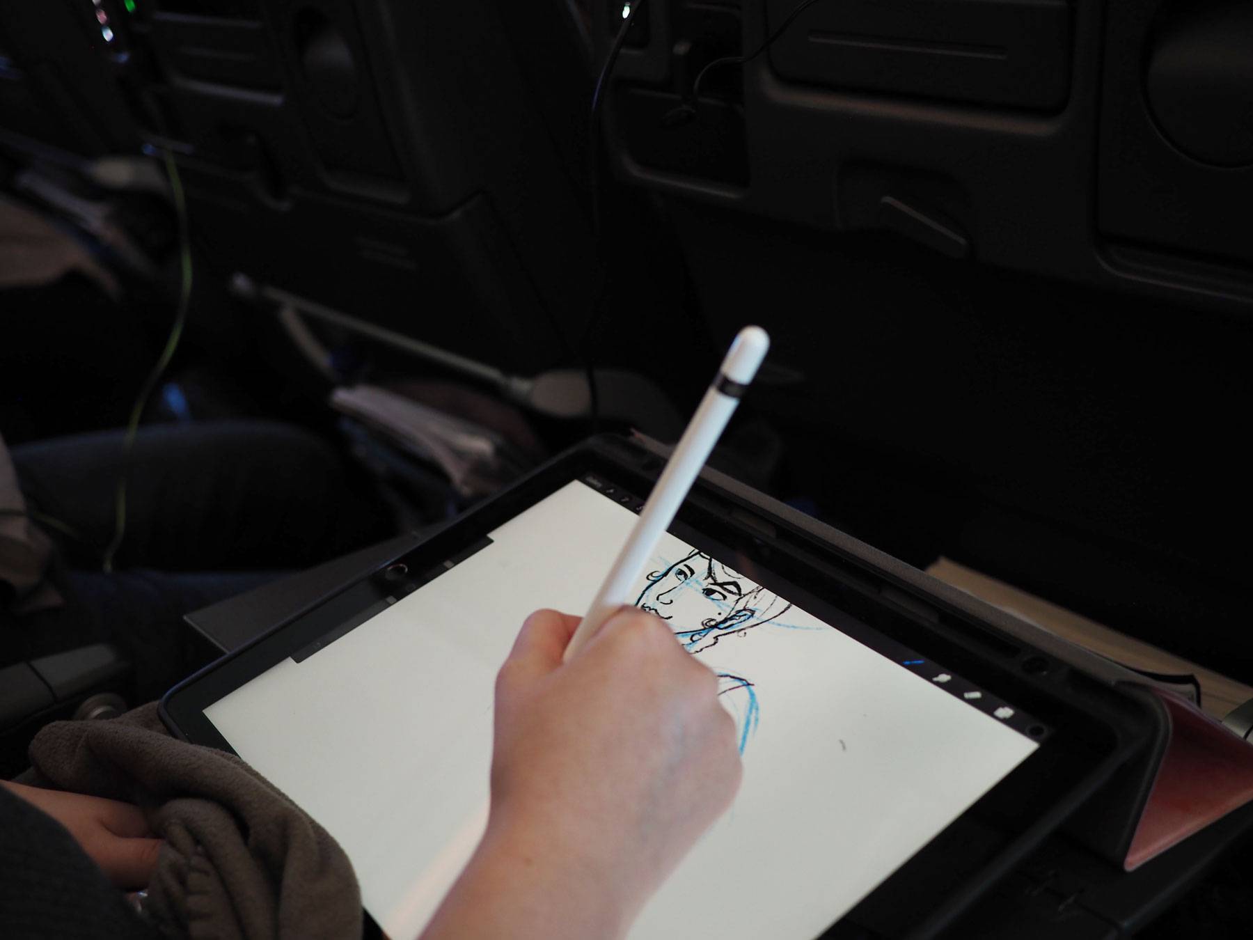 Alyssa sketching on flight