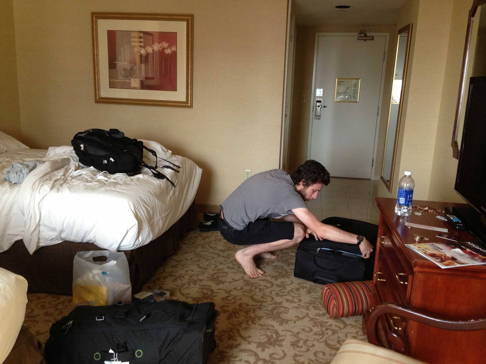 Irwin zipping up his suitcase