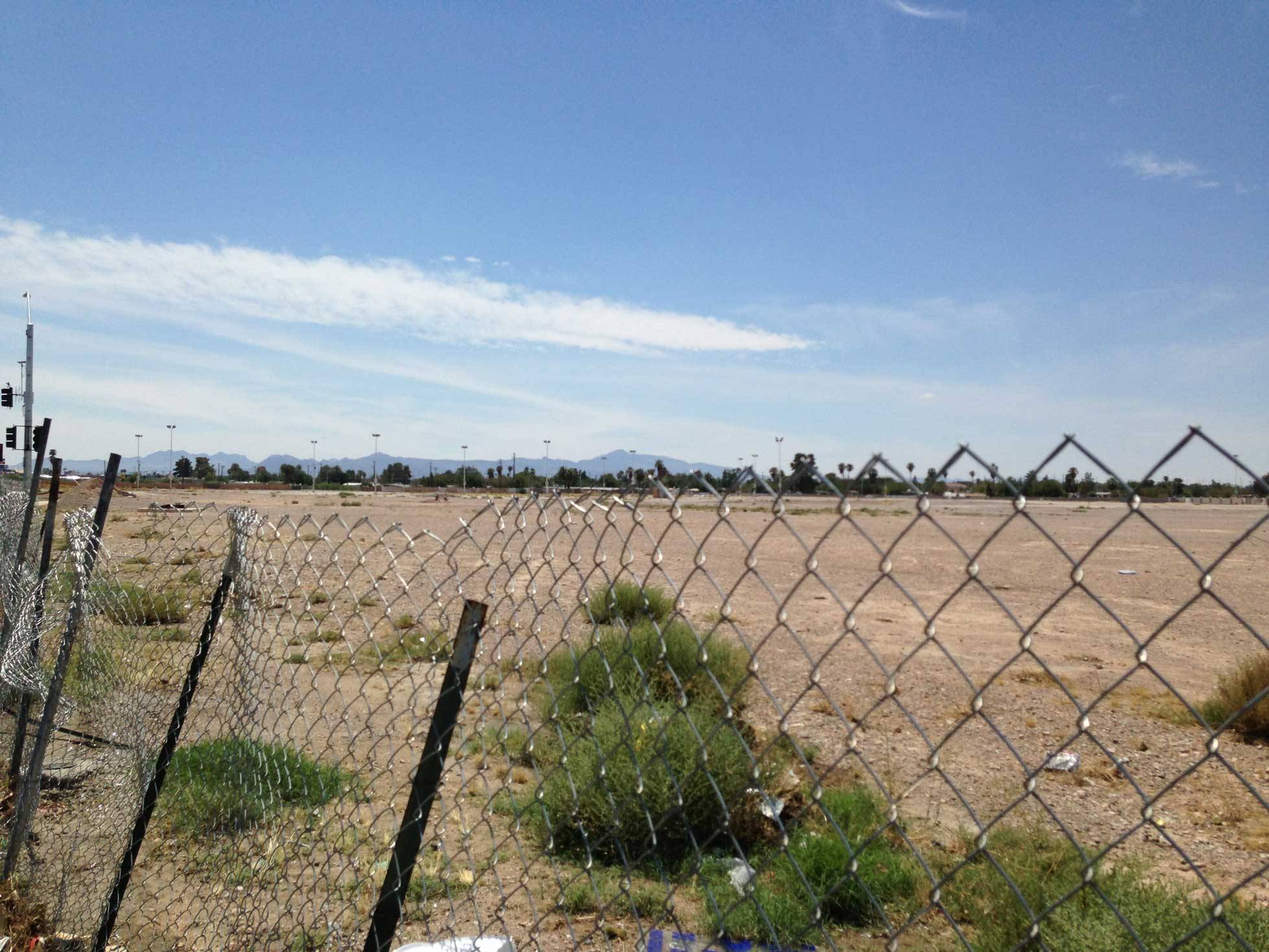 A run down fence with empty property