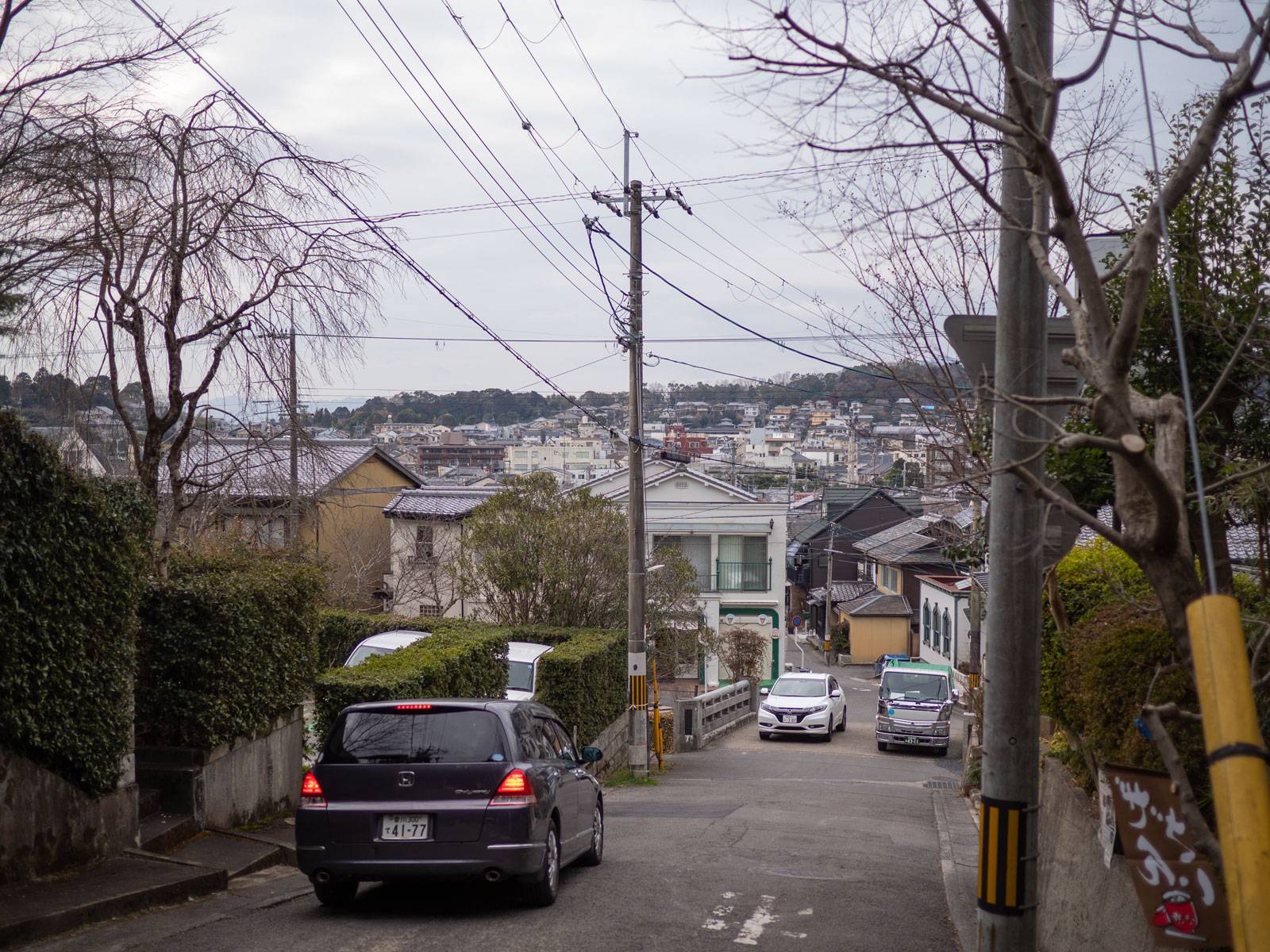 Cars parked along a steep residential street