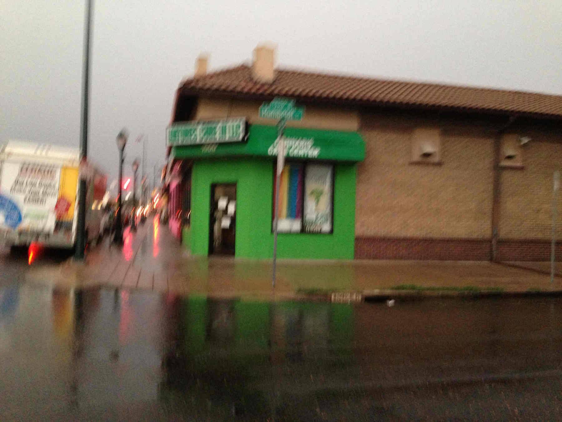 A bright coloured weed dispensary, barely legible through this blurry photo