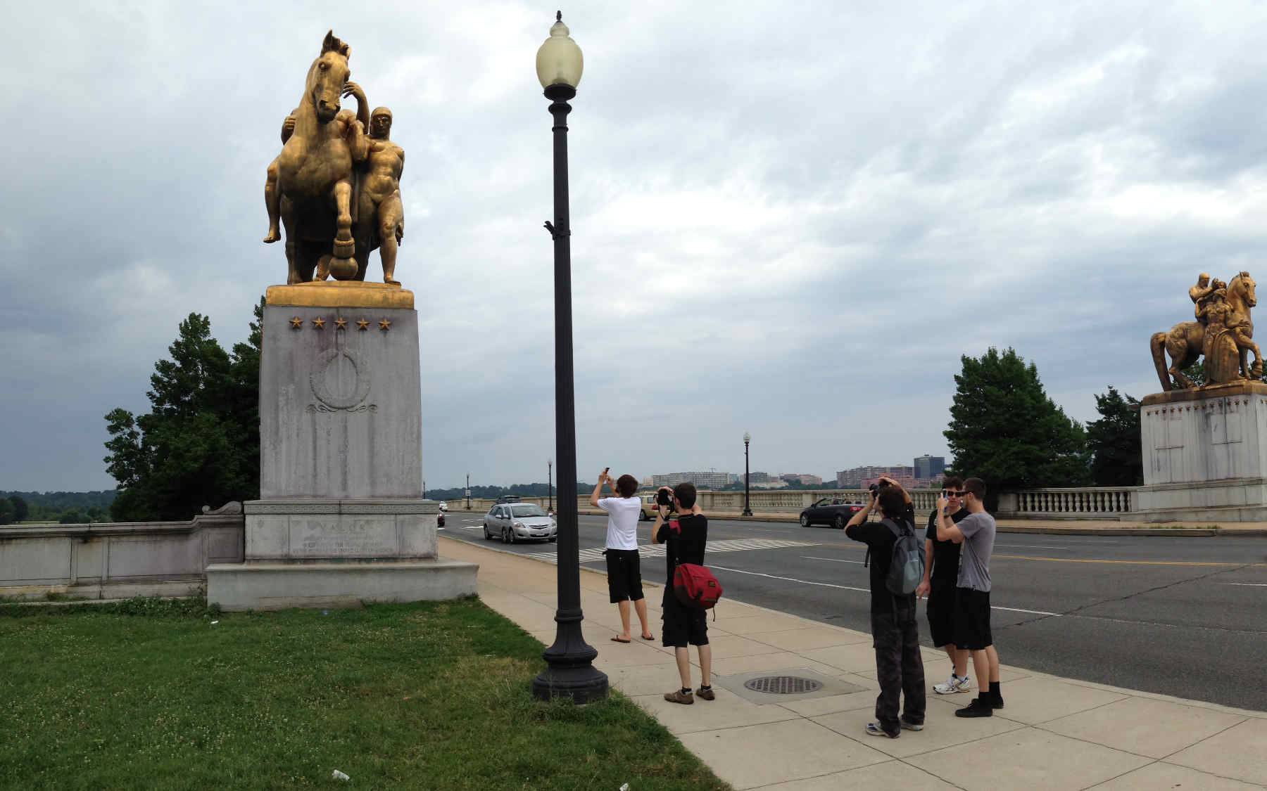 The group taking a photo of a golden statue of a horse